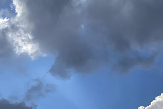 Blue sky with white and grey clouds. Photo.